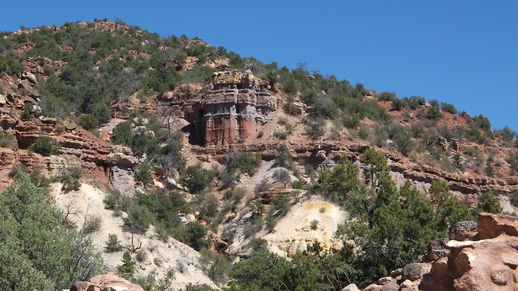 The hillside above the church grounds. Millions of years ago volcano's were common in NM